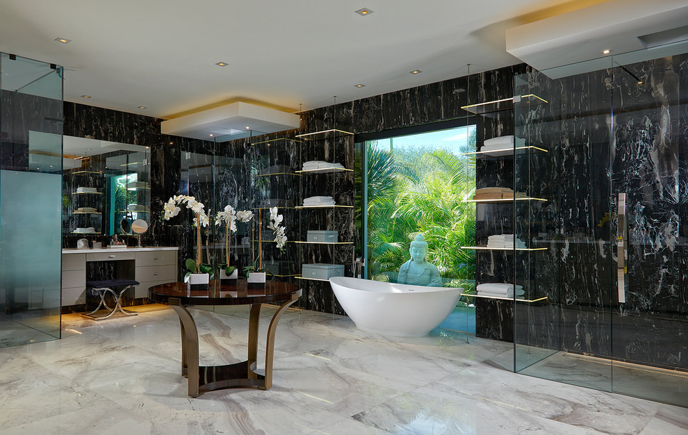 This is an example of an expansive contemporary master bathroom in Miami with flat-panel cabinets, beige cabinets, a freestanding tub, black and white tile, black walls and grey floor.