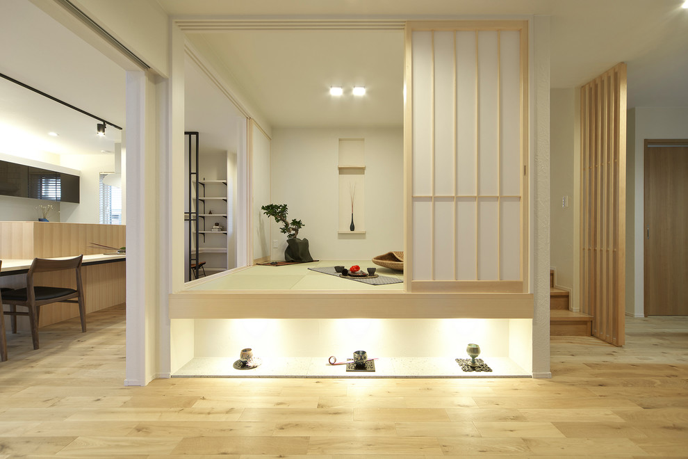 Asian family room in Other with white walls, tatami floors and green floor.