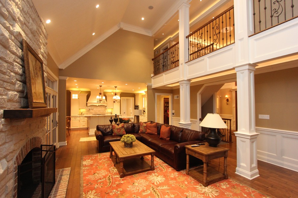 Living room - large transitional open concept medium tone wood floor living room idea in Other with beige walls, a standard fireplace, a stone fireplace and a tv stand