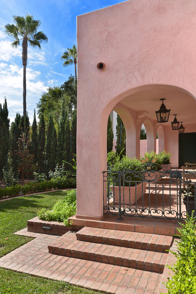 Inspiration for a large traditional three-storey stucco exterior in San Diego.