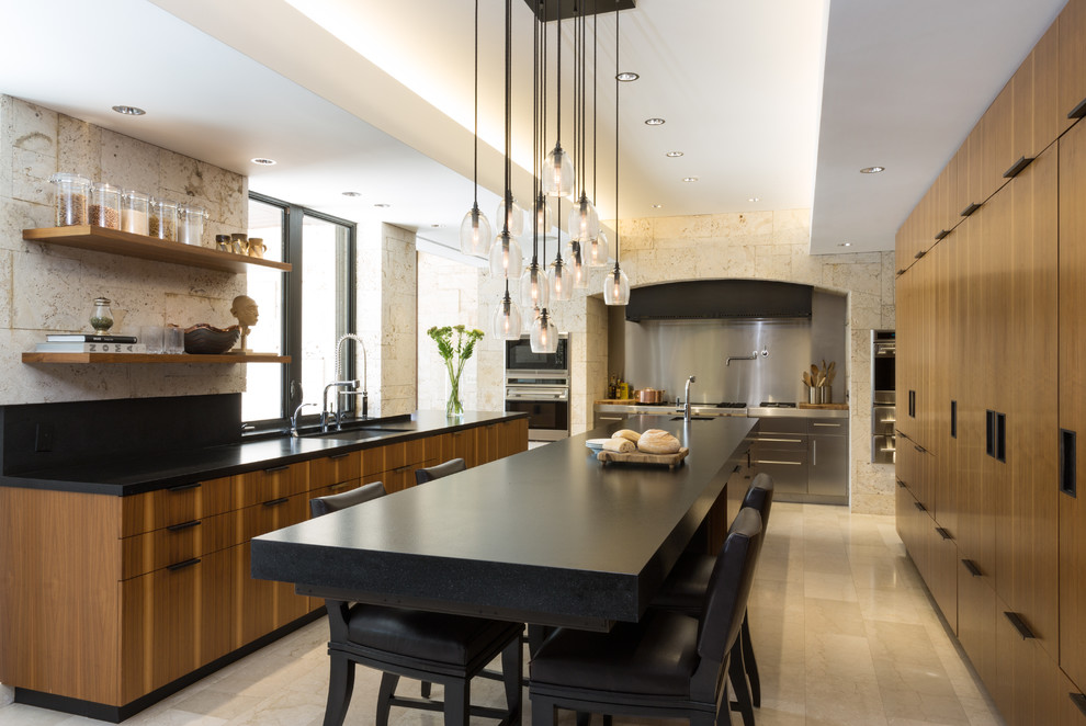 This is an example of a large modern u-shaped eat-in kitchen in New York with granite benchtops, flat-panel cabinets, medium wood cabinets, stainless steel appliances, an undermount sink, porcelain floors and with island.