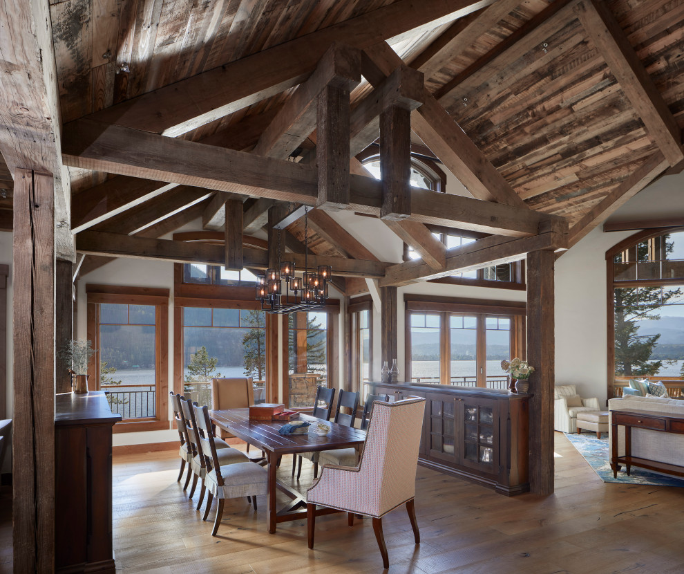 Large rustic open plan dining room in Denver with light hardwood flooring, brown floors and a wood ceiling.