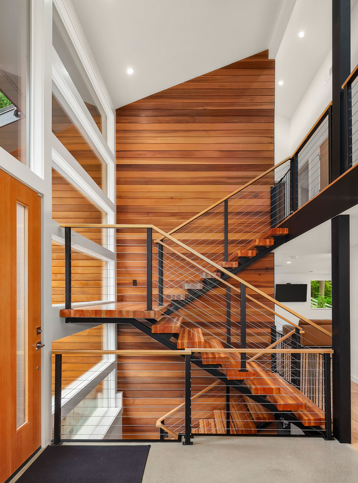 Contemporary wood u-shaped staircase in Seattle with open risers and cable railing.