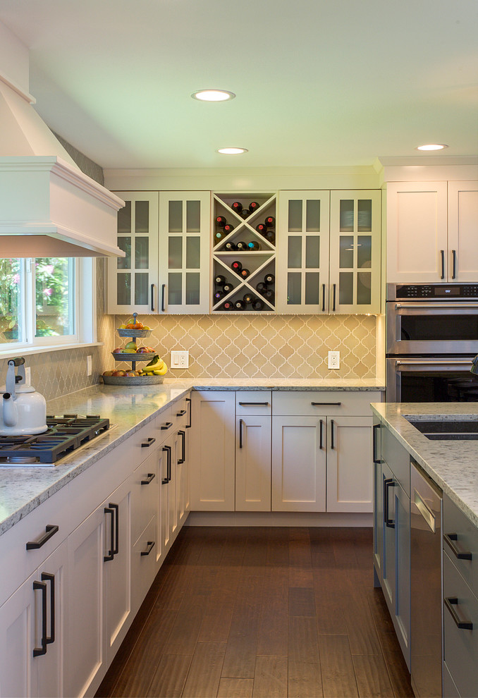 Inspiration for a large country u-shaped dark wood floor open concept kitchen remodel in Seattle with an undermount sink, shaker cabinets, gray cabinets, quartzite countertops, gray backsplash, mosaic tile backsplash, stainless steel appliances and an island