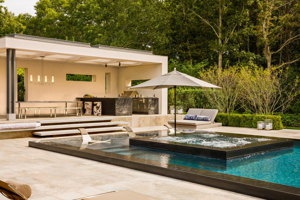 Photo of a large contemporary backyard rectangular pool in New York.