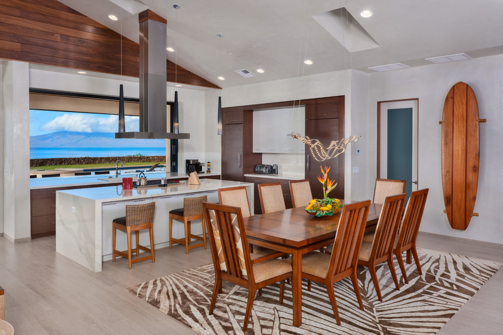 Photo of a mid-sized contemporary kitchen/dining combo in Hawaii with white walls, beige floor, porcelain floors and no fireplace.