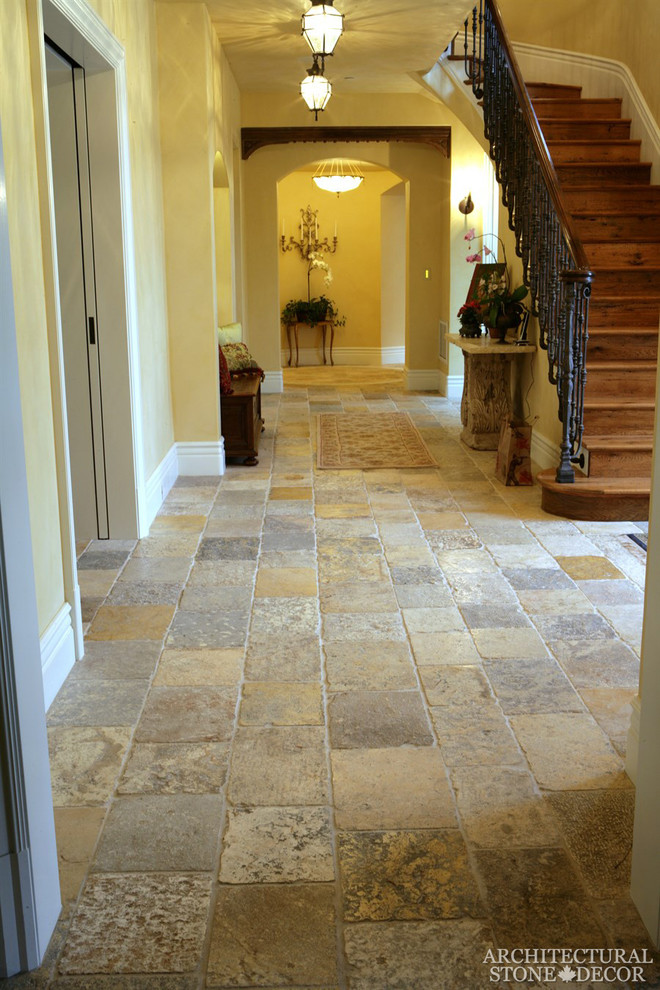 Photo of a mid-sized mediterranean hallway in Toronto with limestone floors.