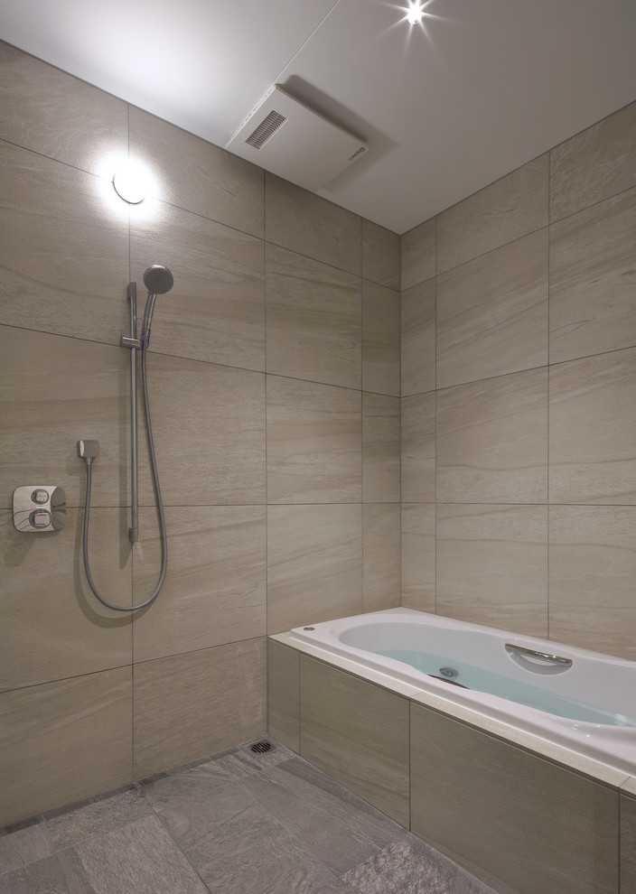 Photo of a modern bathroom in Other with a corner tub, an open shower, beige walls, grey floor and an open shower.