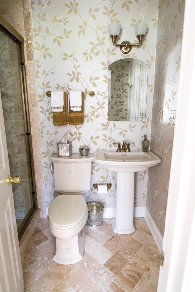 Inspiration for a traditional powder room in Baltimore with a one-piece toilet, beige tile, stone tile, travertine floors and a pedestal sink.