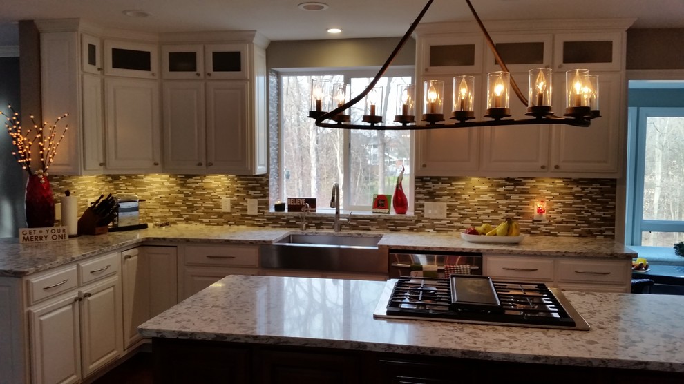 Example of a transitional kitchen design with an island