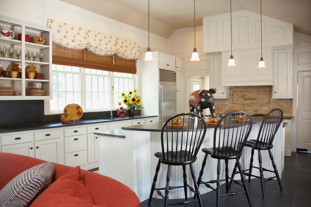 Country l-shaped open plan kitchen in Boston with raised-panel cabinets, white cabinets, soapstone benchtops, beige splashback and stainless steel appliances.