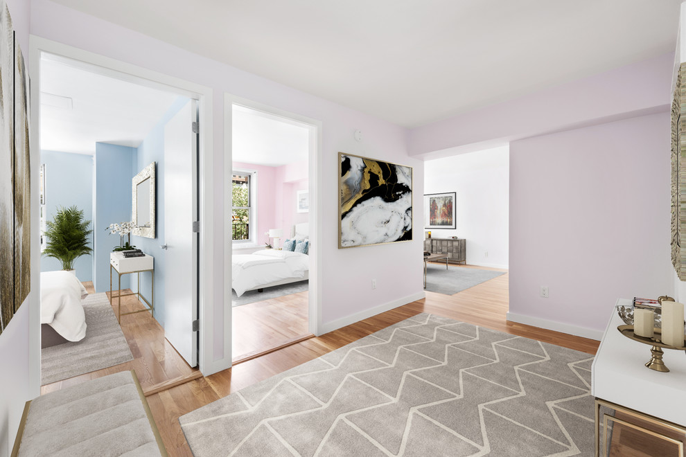 Inspiration for a mid-sized transitional medium tone wood floor and brown floor entryway remodel in New York with pink walls