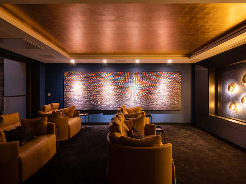Inspiration for a large modern enclosed home cinema in London with blue walls, carpet, a built-in media unit, black floors and feature lighting.