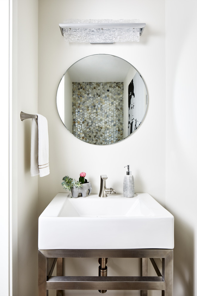 Inspiration for a mid-sized contemporary powder room in DC Metro with furniture-like cabinets, a two-piece toilet, multi-coloured tile, mosaic tile, white walls and a pedestal sink.