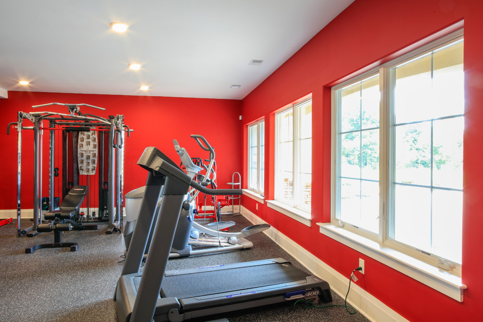 Photo of an expansive contemporary multipurpose gym in New York with red walls.