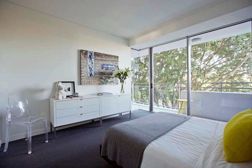 This is an example of a small contemporary master bedroom in Brisbane with white walls and carpet.