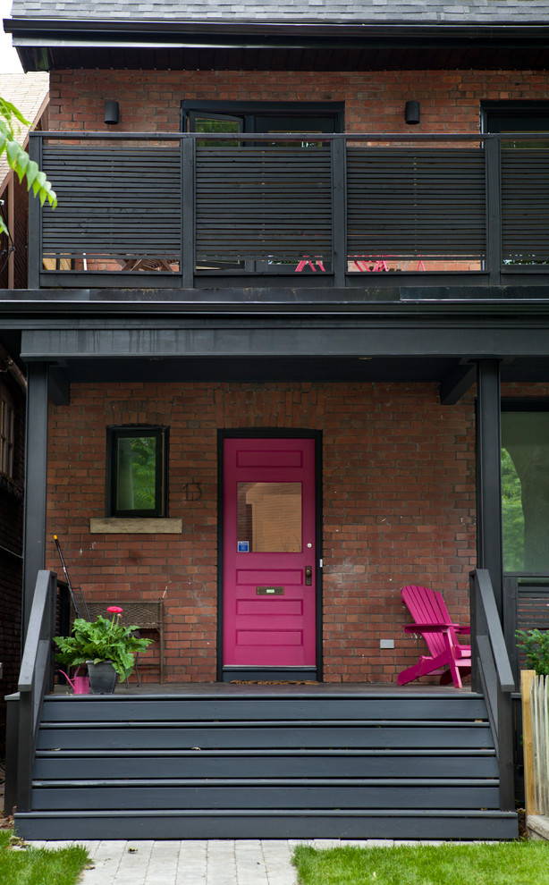 Mid-sized eclectic front yard verandah in Toronto with a roof extension.