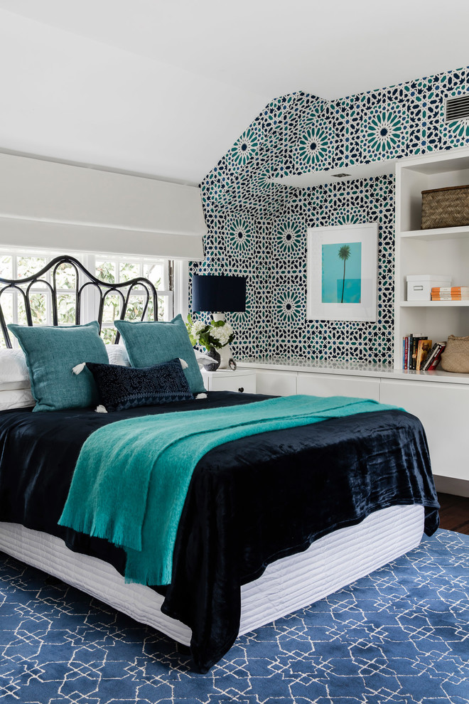 Large eclectic guest bedroom in Sydney with multi-coloured walls and dark hardwood floors.