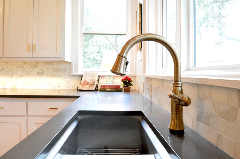 Example of a kitchen design in Austin with an undermount sink, quartz countertops, white backsplash and stone tile backsplash
