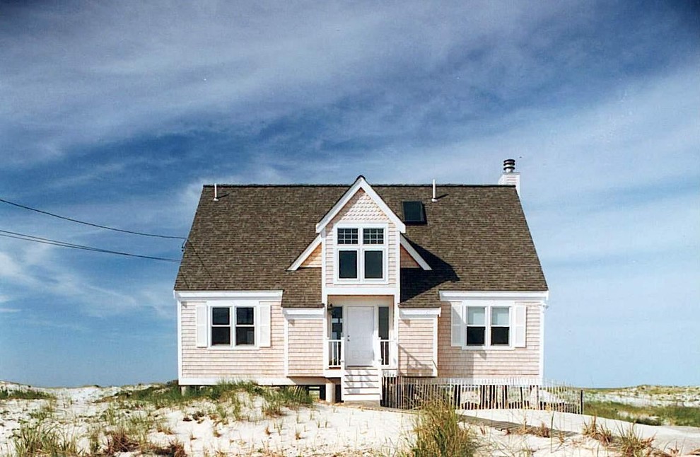 This is an example of a small beach style two-storey exterior in Boston with wood siding.