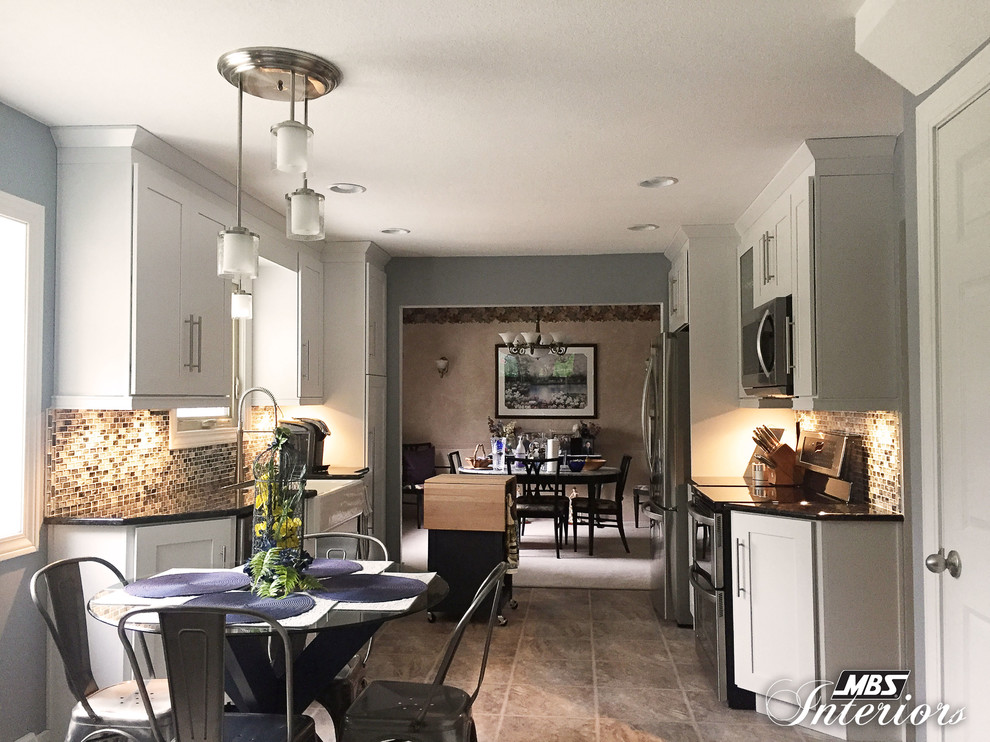 Eat-in kitchen - mid-sized transitional galley ceramic tile and beige floor eat-in kitchen idea with a farmhouse sink, white cabinets, stainless steel appliances, shaker cabinets, granite countertops, blue backsplash, glass sheet backsplash and an island
