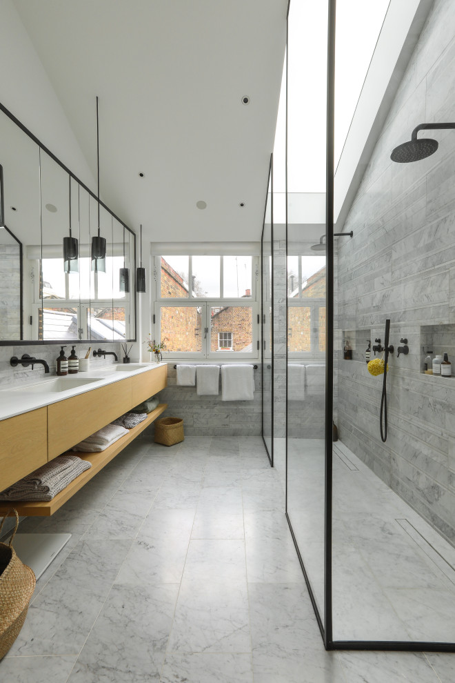 Photo of an expansive contemporary master bathroom in London with flat-panel cabinets, light wood cabinets, a curbless shower, gray tile, an undermount sink, grey floor, an open shower, white benchtops, a double vanity and a floating vanity.