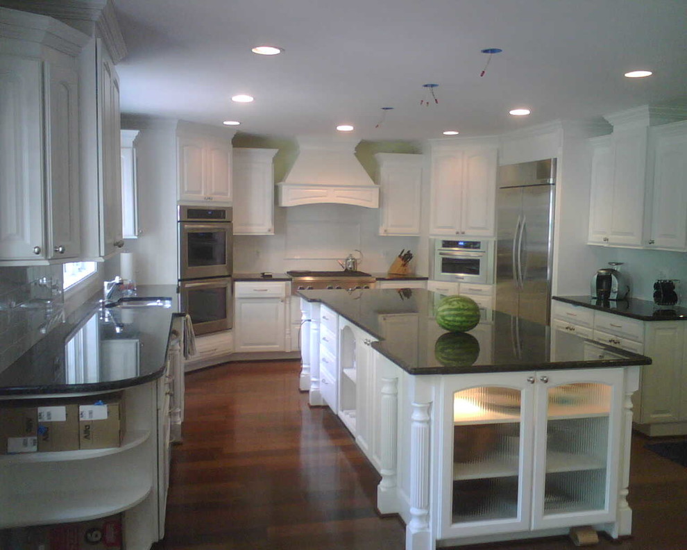 Kitchen - dark wood floor kitchen idea in DC Metro with white cabinets and stainless steel appliances