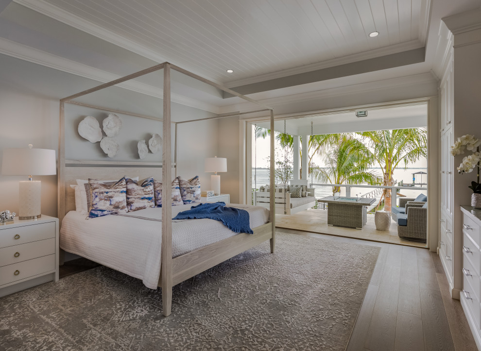 Inspiration for a beach style master bedroom in Tampa with recessed.