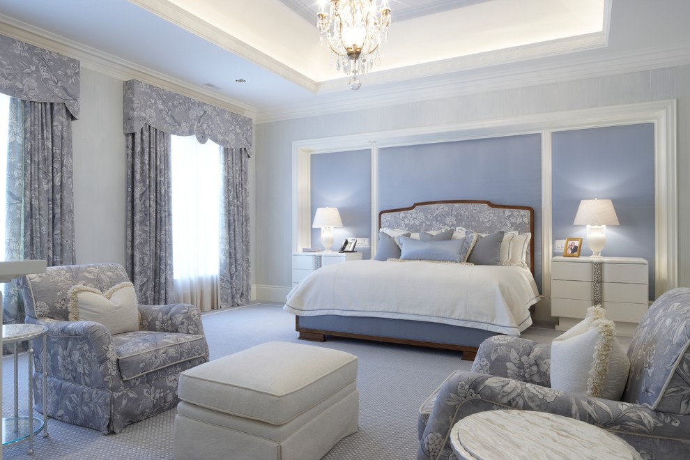 Photo of a large traditional master bedroom in Toronto with blue walls and carpet.