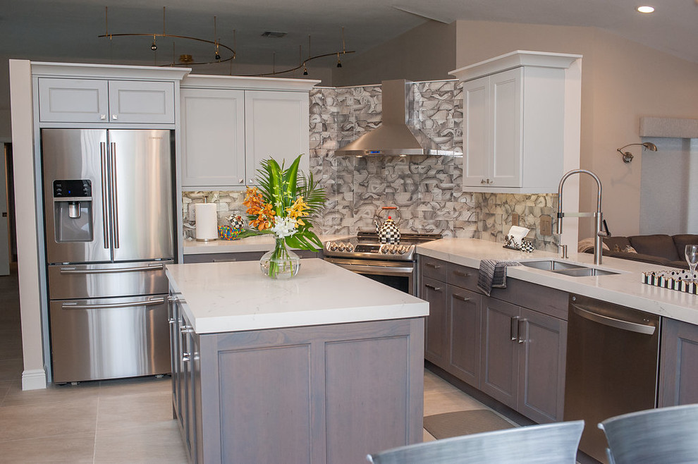 Inspiration for a mid-sized transitional u-shaped porcelain tile and beige floor eat-in kitchen remodel in Miami with an undermount sink, shaker cabinets, gray cabinets, quartz countertops, gray backsplash, glass tile backsplash, stainless steel appliances, an island and white countertops