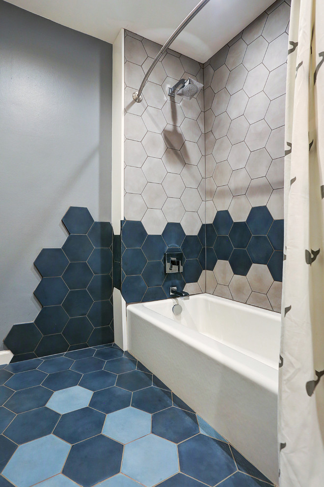 This is an example of a contemporary bathroom in Houston with an alcove tub, a shower/bathtub combo, multi-coloured tile, cement tile and grey walls.