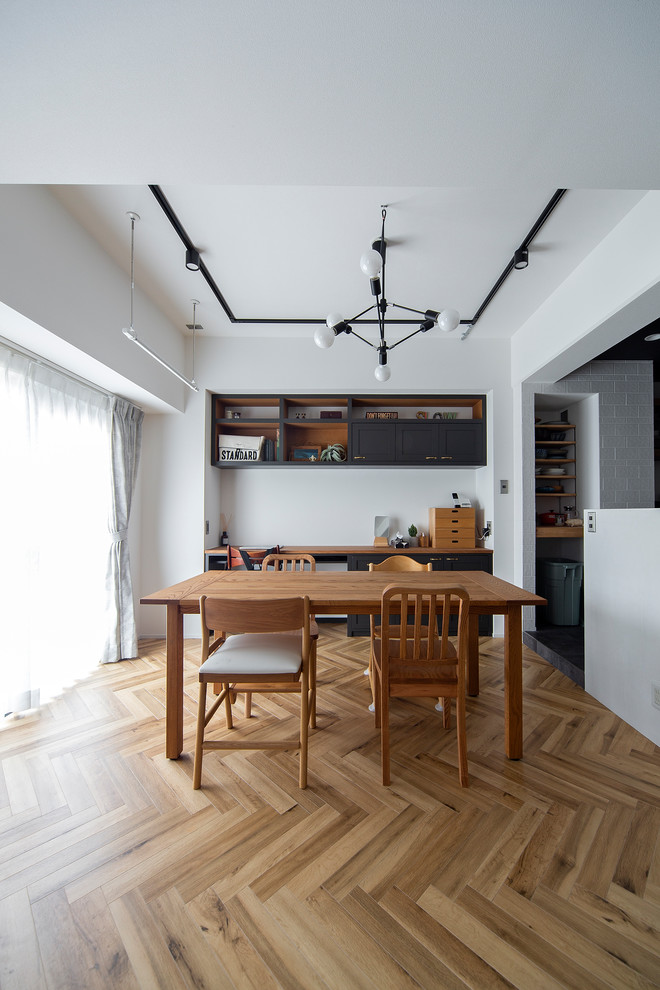Design ideas for a contemporary dining room in Osaka with white walls, medium hardwood floors and brown floor.