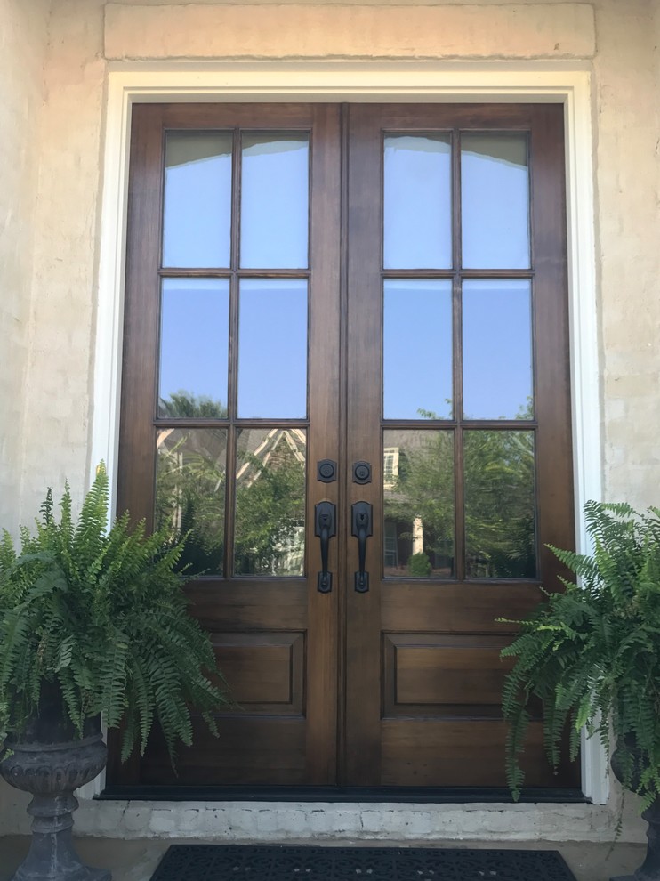 Mid-sized traditional front door in Other with beige walls, a double front door and a dark wood front door.