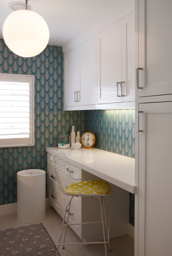 Design ideas for a transitional laundry room in Orange County with white cabinets, blue walls and white benchtop.