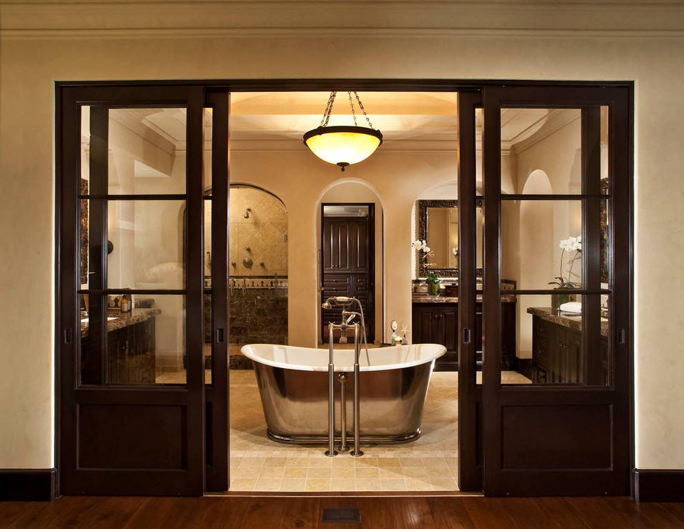 Inspiration for a large traditional master bathroom in Orange County with a freestanding tub, dark wood cabinets, an open shower, beige walls, ceramic floors, an undermount sink and granite benchtops.
