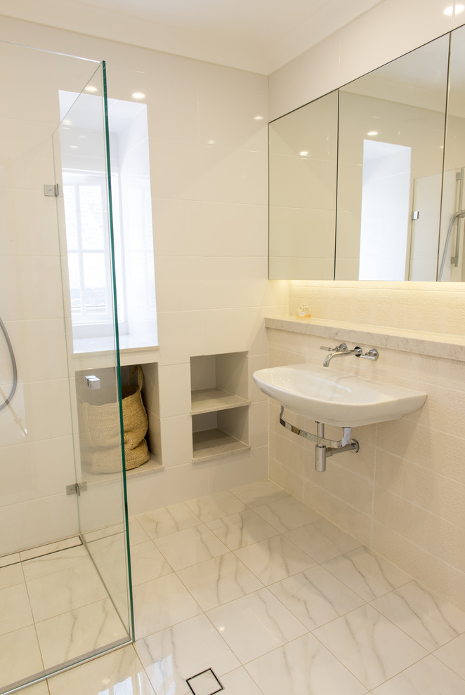 This is an example of a contemporary bathroom in Other with a curbless shower, white tile and marble floors.