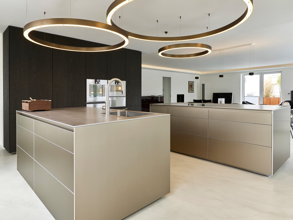 Large modern u-shaped open plan kitchen in Munich with an integrated sink, flat-panel cabinets, brown cabinets, stainless steel appliances, concrete floors, multiple islands and beige floor.
