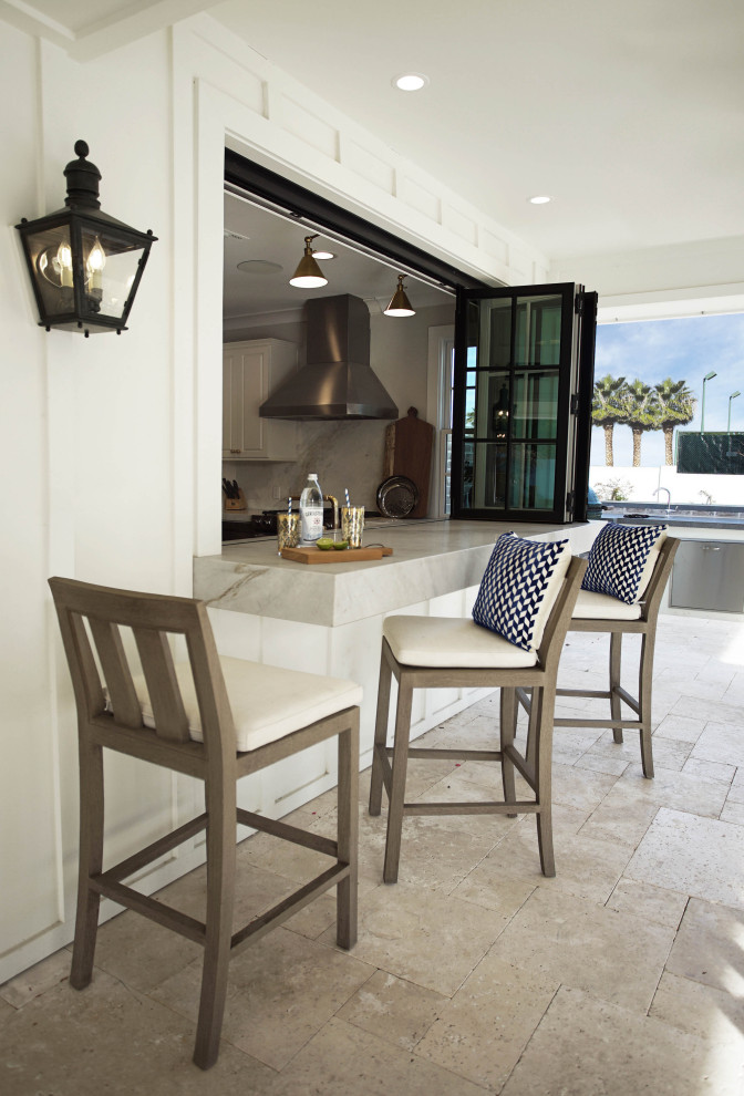 Mid-sized transitional l-shaped medium tone wood floor and brown floor open concept kitchen photo in Phoenix with a farmhouse sink, raised-panel cabinets, white cabinets, marble countertops, white backsplash, stone slab backsplash, stainless steel appliances, an island and white countertops