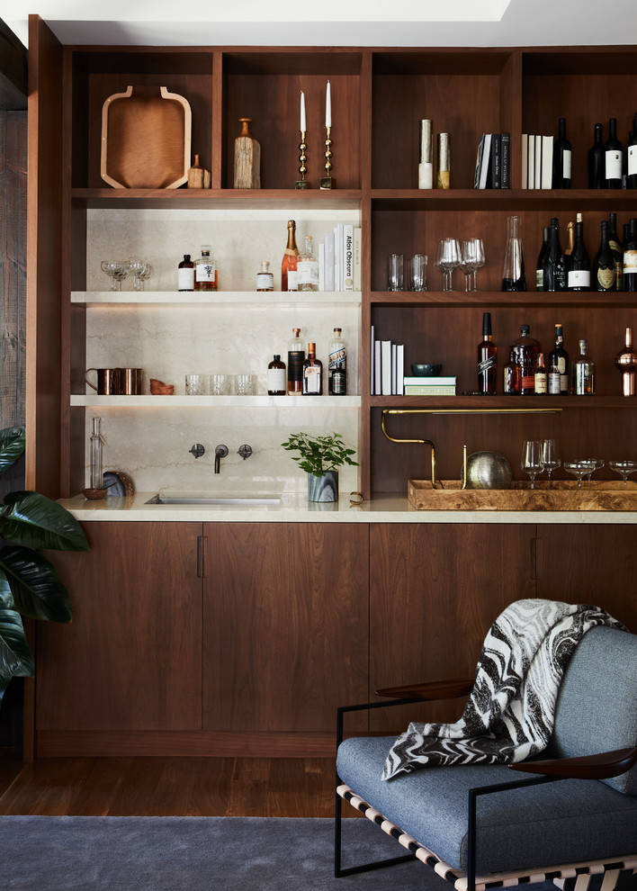 Design ideas for a contemporary single-wall wet bar in San Francisco with an undermount sink, flat-panel cabinets, dark wood cabinets, white splashback, dark hardwood floors, brown floor and white benchtop.