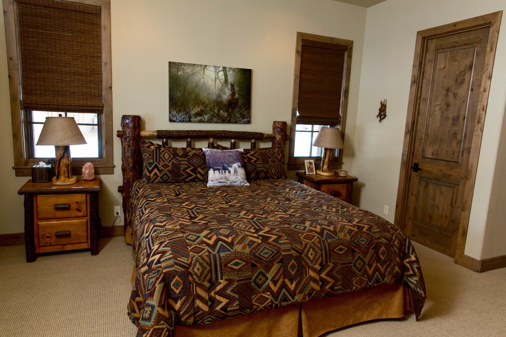 Inspiration for a mid-sized rustic carpeted and beige floor bedroom remodel in Phoenix with beige walls and no fireplace