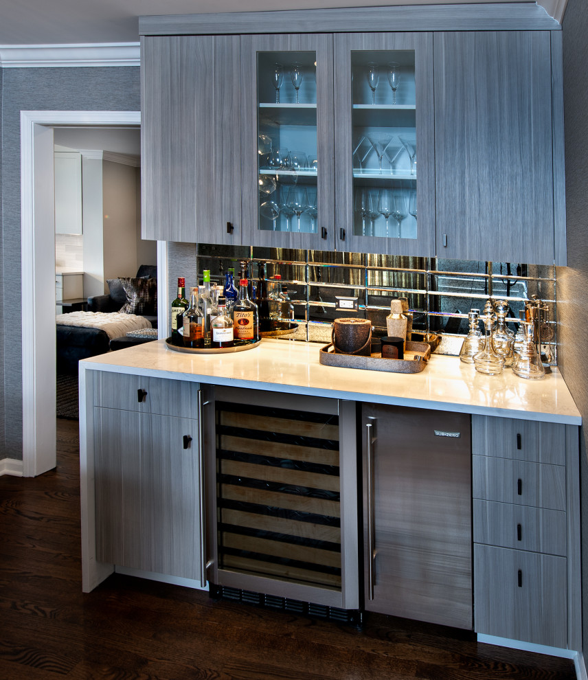 Contemporary home bar in Chicago with flat-panel cabinets, distressed cabinets, quartz benchtops, multi-coloured splashback, mirror splashback and grey benchtop.