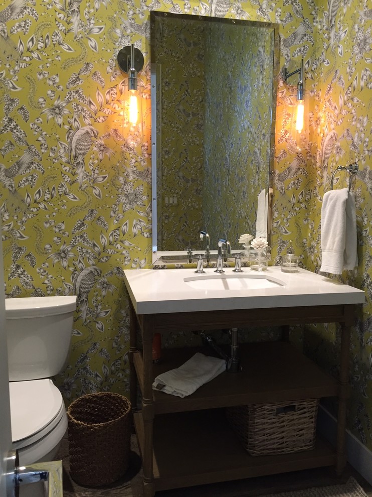Design ideas for a mid-sized transitional powder room in Sacramento with furniture-like cabinets, green walls and an undermount sink.