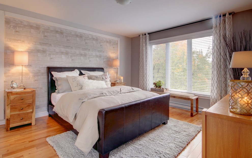 Photo of a country bedroom in Montreal with grey walls and medium hardwood floors.