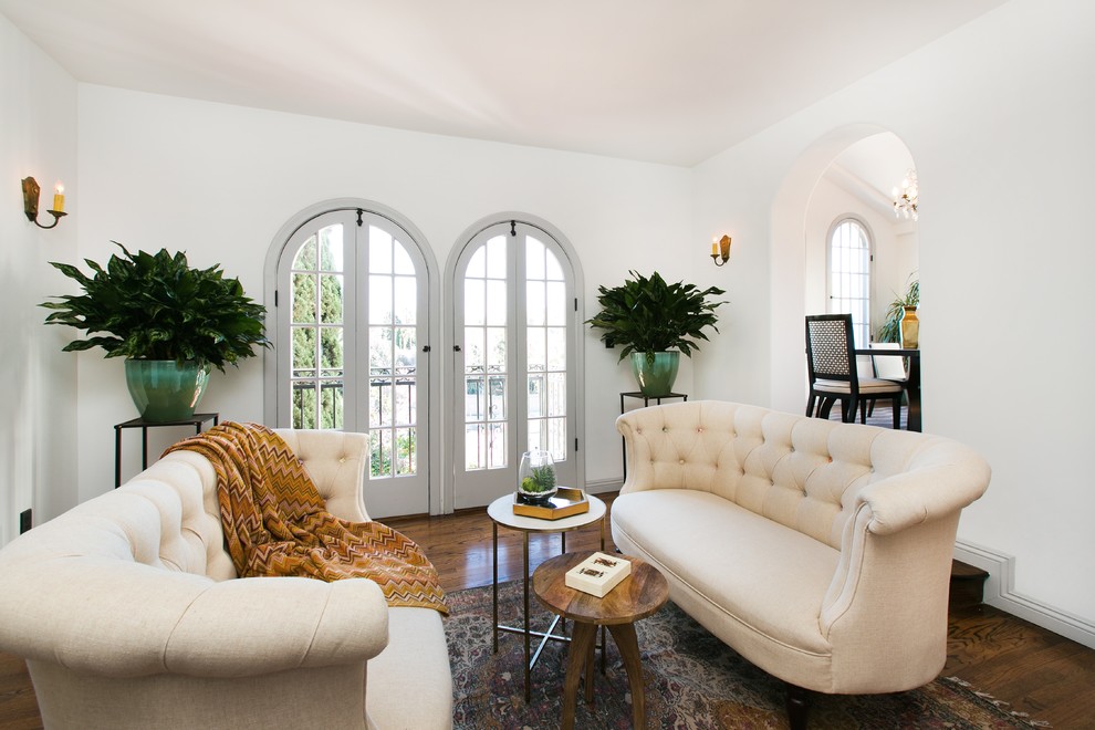 Inspiration for a mid-sized mediterranean formal enclosed living room in Los Angeles with white walls, dark hardwood floors, no fireplace and no tv.