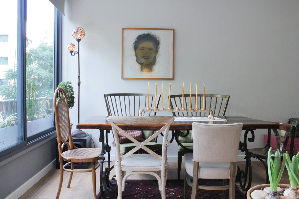 Inspiration for an eclectic dining room in Tel Aviv with white walls and medium hardwood floors.
