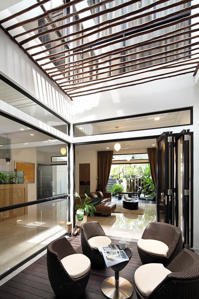 Photo of a contemporary courtyard patio in Singapore with decking and a pergola.
