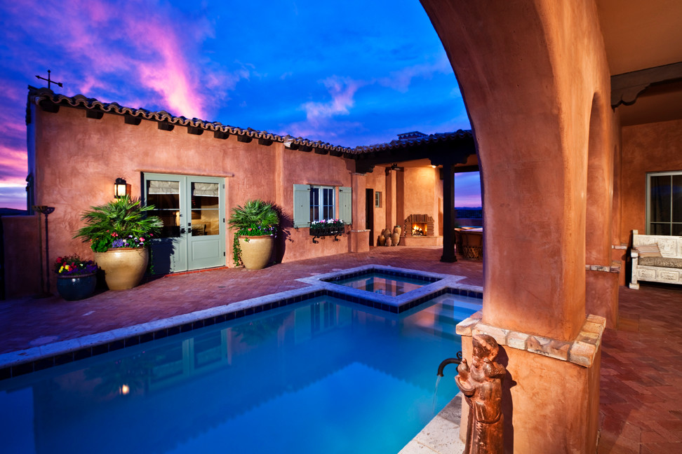 Inspiration for a mid-sized courtyard rectangular natural pool in Phoenix with brick pavers and a hot tub.
