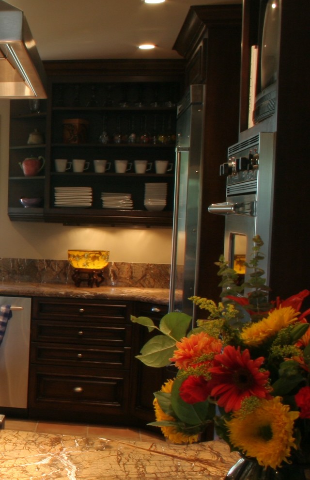 Open concept kitchen - large transitional u-shaped terra-cotta tile open concept kitchen idea with a farmhouse sink, furniture-like cabinets, dark wood cabinets, granite countertops, stone slab backsplash, stainless steel appliances, white walls and an island