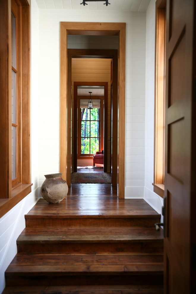Inspiration for a country hallway in Seattle with white walls and dark hardwood floors.