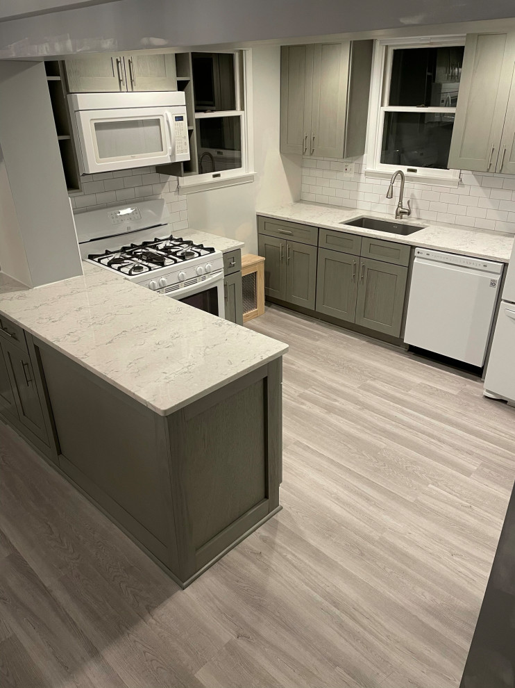 This is an example of a small galley eat-in kitchen in DC Metro with shaker cabinets, grey cabinets, quartzite benchtops, vinyl floors, multiple islands, grey floor and multi-coloured benchtop.
